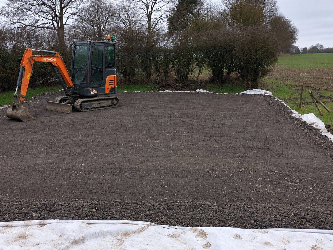 The same plot cleared, with a hardcore base laid and levelled
